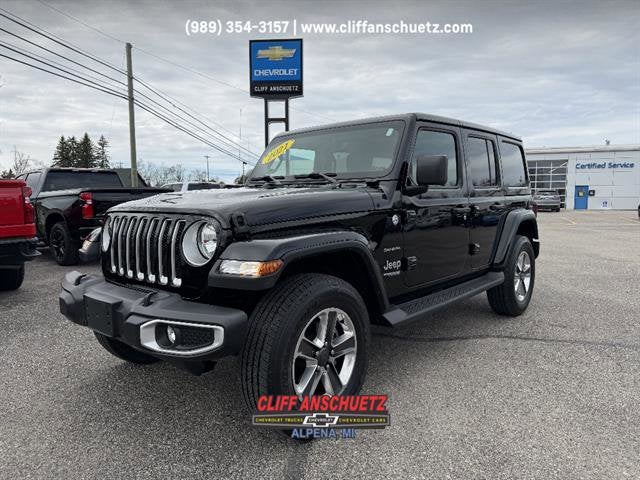 2021 Jeep Wrangler Unlimited Sahara in Black — front three-quarter view